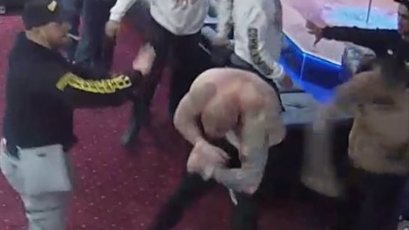 Paea Talakai, 27, (right) throwing a punch. He has pleaded guilty to affray in the ACT Magistrates Court after a wild bikie brawl in a Canberra strip club, the Capital Mens Club.