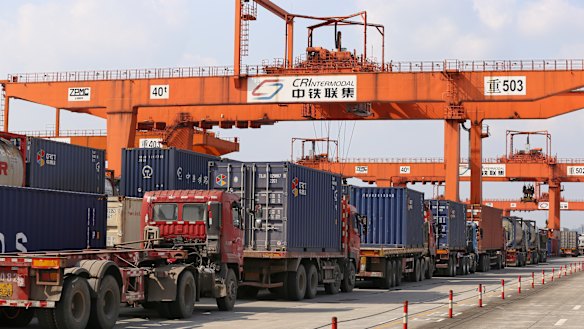 Trucks lined up to load containers at Chongqing Western Logistics Park .