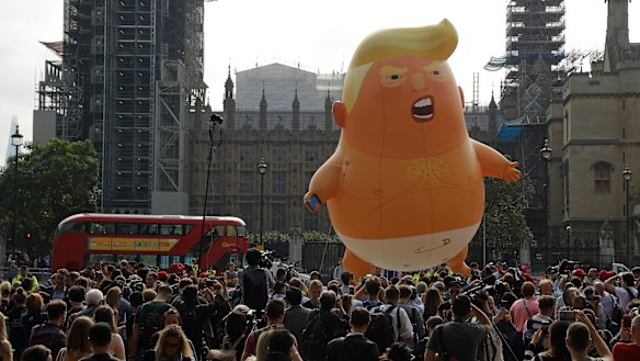 A six-meter high baby blimp of Donald Trump is flown as a protest against his visit, in Parliament Square backdropped by the scaffolded Houses of Parliament and Big Ben in London on Friday.