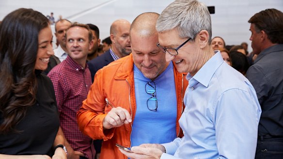 Apple's Tim Cook and Jony Ive look at the new iPhone X. Cook says he has put boundaries on his nephew using social media.