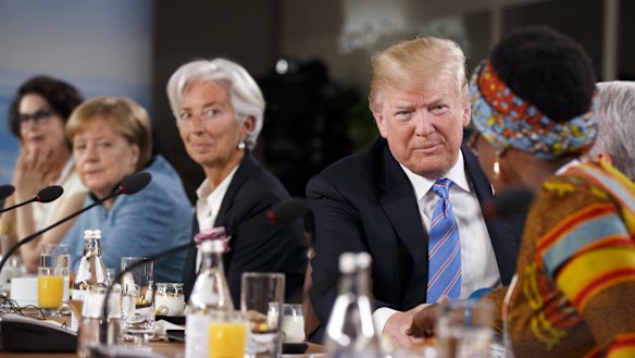 US President Donald Trump, second right, shakes hands with Winnie Byanyima, executive director of Oxfam International, after arriving late for the Group of Seven (G7) Gender Equality Advisory Council Breakfast at the G7 Leaders Summit in La Malbaie, Quebec, Canada.