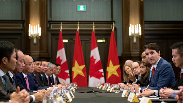 Canadian Prime Minister Justin Trudeau, right, meets with the Prime Minister of Vietnam, third from left, Nguyen Xuan Phuc,on the sides of the G7.