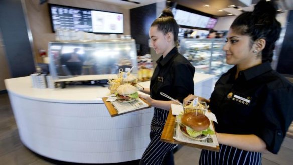 Gastro-pub influence: Macca's crew deliver gourmet burgers on wooden boards.