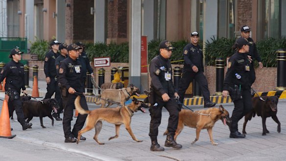 Bomb sniffing dogs walk outside a hotel at the Resorts World Manila complex.