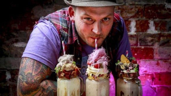 Ashley de' Hartman, co-owner of Naughty Boy Cafe in Brunswick, with the freakshakes.