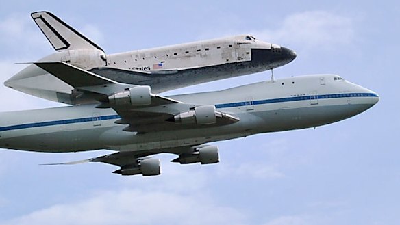 The space shuttle Discovery travels on the back of a Boeing 747 jumbo jet to its final destination - a museum outside Washington.