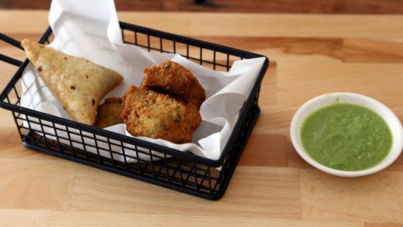 Triangular sambusa (ground beef pastry parcel) and bajeya (Somali-style falafel) at New Somali Kitchen.