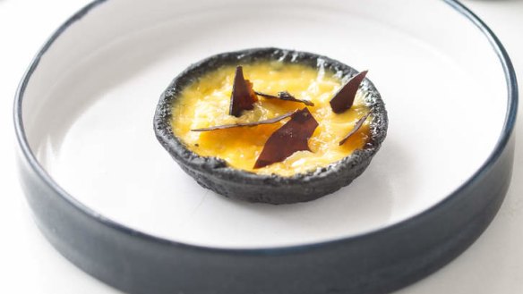 Sweet and salty: Vegemite, lychee and cheese charcoal tart.