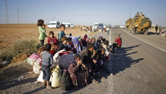 Syrian Kurdish refugees after crossing into Turkey.