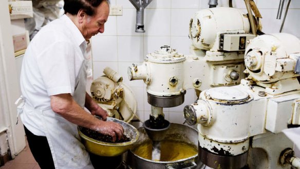 The dough is mixed in this battered industrial mixer three times.