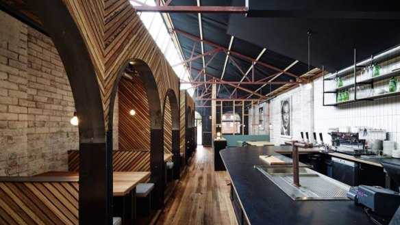 The converted warehouse features striking timber-framed booths.