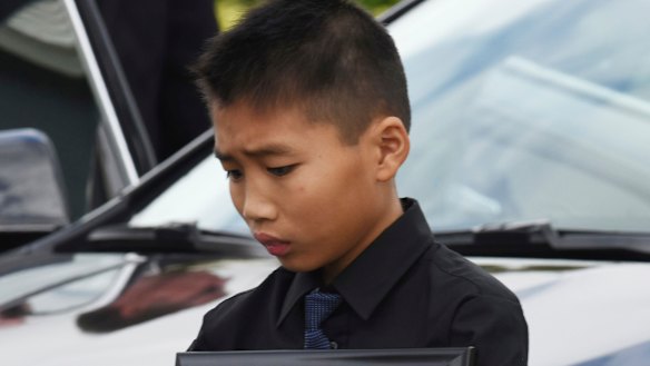Alex Wang holds a picture of his brother, Peter Wang, a victim in the shooting at Marjory Stoneman Douglas High School.