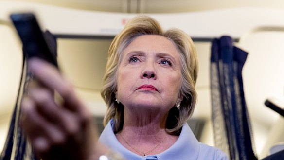 Democratic presidential candidate Hillary Clinton takes a question from a member of the media on her campaign plane.