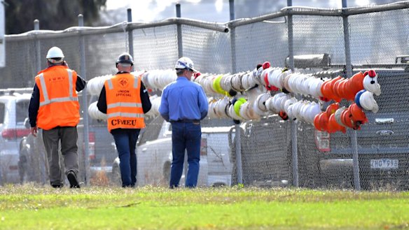 Union officials look at helmets one for each job lost, outside the Hazelwood plant. 
