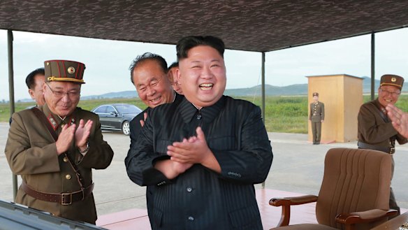 North Korean leader Kim Jong-un, center, celebrates his latest missile test launch on Friday. Independent journalists were not given access.