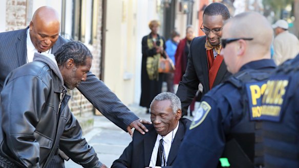 John Pinckney, father of shooting victim Reverend Clementa Pinckney, is greeted after leaving the Courthouse in Charleston in December. 