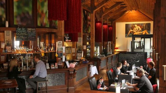 Eighty One's main room features tasselled red light fittings and grand beams.