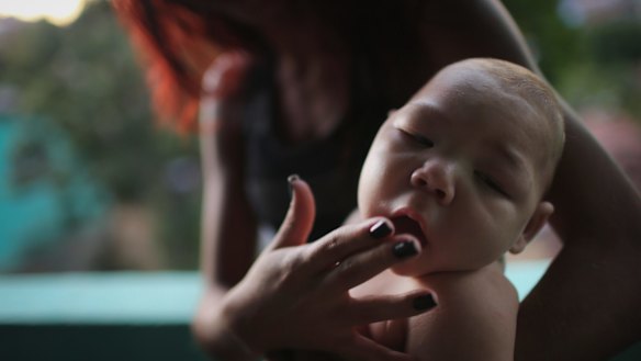 Estafany Perreira holds her five-month-old nephew David Henrique Ferreira, who has microcephaly. 
