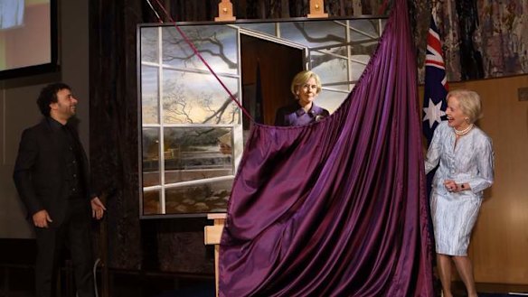 Outgoing Governor-General Dame Quentin Bryce helps to unveil her official portrait. Photo: Andrew Meares