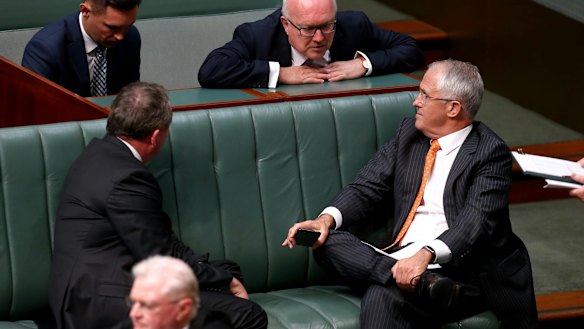 Deputy Prime Minister Barnaby Joyce, Attorney-General Senator George Brandis and Prime Minister Malcolm Turnbull in discussion during a division in the House of Representatives in Canberra on Monday.