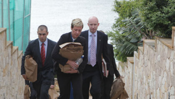 Seized ... police remove documents from Ron Medich’s Point Piper mansion.