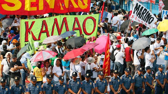 Police surround protesters at a rally to protest the continuing killings under Philippine President Rodrigo Duterte's war on drugs.