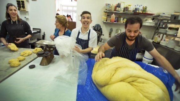 Hellas Cakes bakers including co-owner Andrew Kantaras, right, make Greek sweet bread for Easter with the help of family and staff.