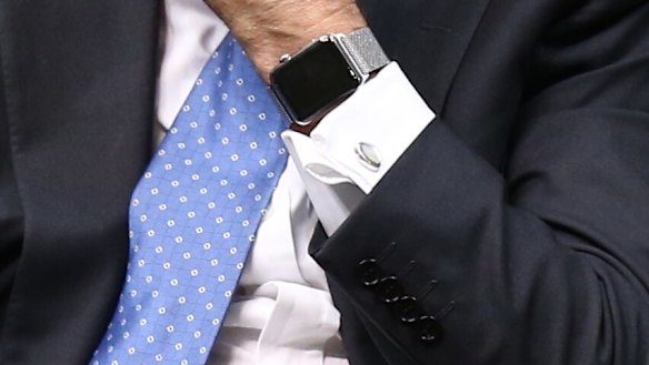 Communications Minister Malcolm Turnbull adjusts his Apple watch during question time  on Thursday.