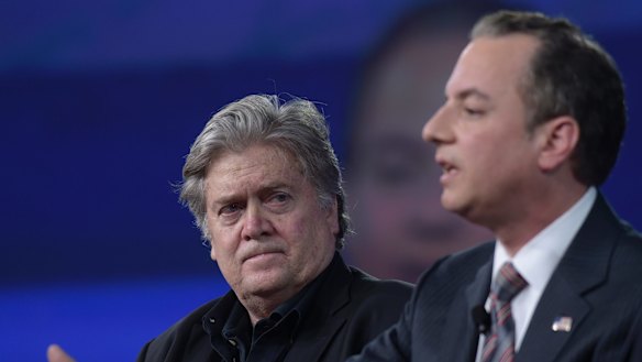 White House strategist Stephen Bannon listens as Reince Priebus speaks.