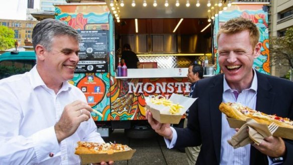 Justin Parry-Okeden and Ian Hudspith lunch on pulled pork rolls from the Monster Roll truck in Queen's Square.
