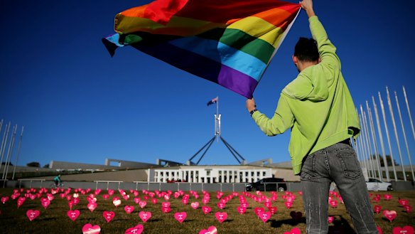 Marriage equality advocate Russell Nankervis with the rainbow flag during a 'Sea of Hearts' event in support of marriage equality at Parliament House earlier this month.