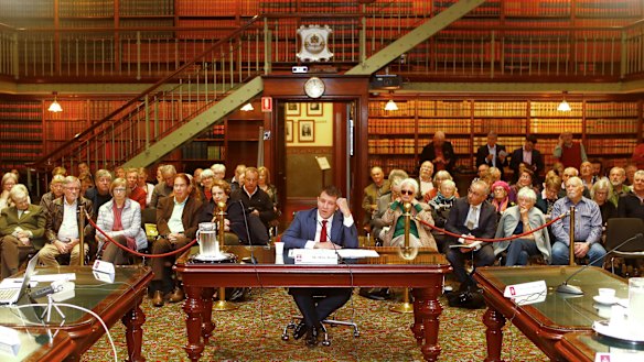 Mike Baird gives evidence before a packed public gallery. 
