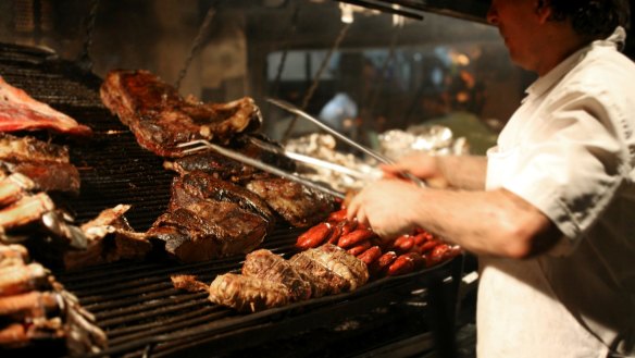 Grill master: a chef cooks meat on a parilla grill in Argentina.