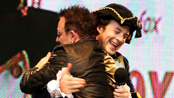 Hamish Blake receives a hug from Bono.