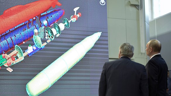 Russian President Vladimir Putin, right, listens to President of National Research Centre which oversees Russian nuclear technology developments.