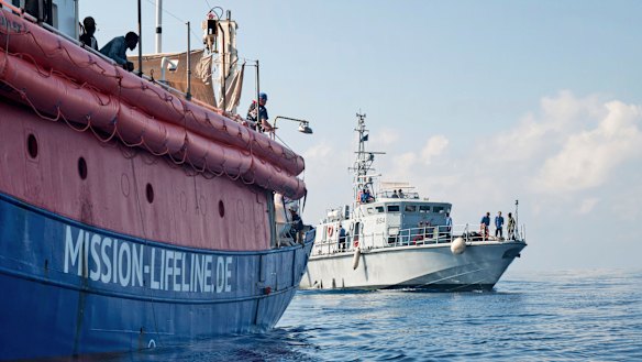 Lifeline is reached by a Libyan Coast Guard boat after rescuing migrants from a rubber boat in the Mediterranean Sea on Thursday.