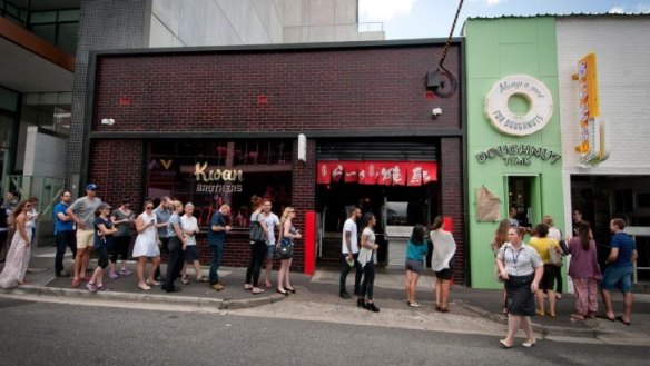 Sweet tooths queue at the original Doughnut Time outlet in Fortitude Valley.