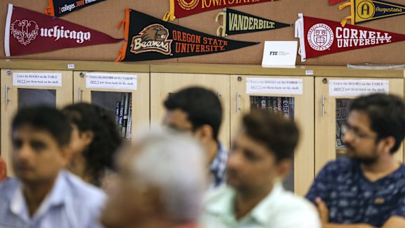 US universities banners are displayed at a session by the University of Southern California Education Foundation in Mumbai, last month. Indian students in the US are often snapped by companies like Google and Microsoft. 