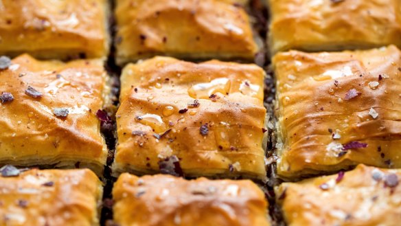 Drizzle the baklava squares with reserved syrup and scatter with rose petals. 