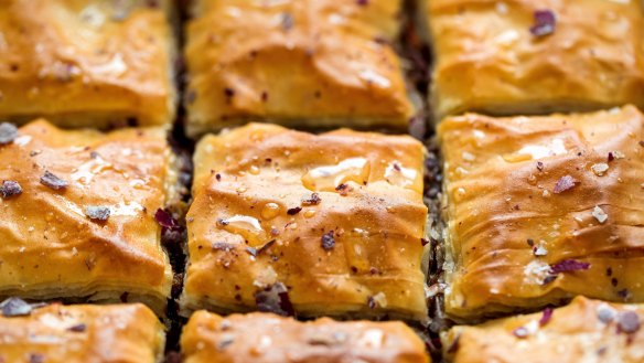 Drizzle the baklava squares with reserved syrup and scatter with rose petals. 