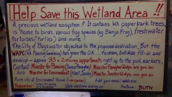 A sign hung from a tree at the site. 