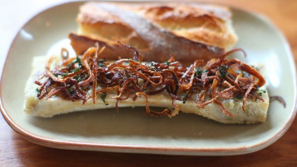 Roasted bone marrow topped with thyme and onion.