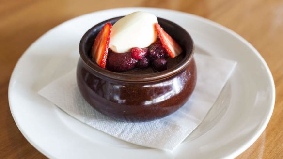 Bitter chocolate pudding with berries.