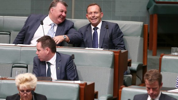 Liberal MP Craig Kelly in discussion with former prime minister Tony Abbott  during question time on Monday.