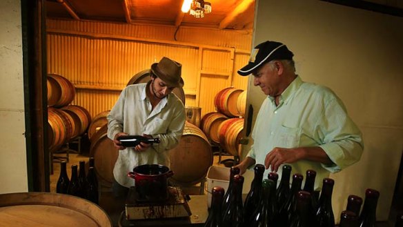 Winemakers: Richard  Harkham and his father Terry Harkham hand wax the corks of their Aziza's 2013 Shiraz at their Pokolbin Winery.