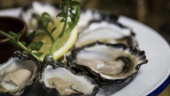 Sydney rock oysters with lemon wedge.