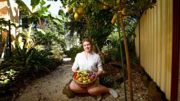 Rebecca Stiegler with produce she has grown in her backyard garden. As well as many vegetables she has over 100 fruit trees.