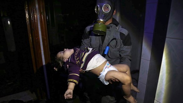 A rescue worker carries a child following an alleged chemical weapons attack in the rebel-held town of Douma, near Damascus, on Saturday night.