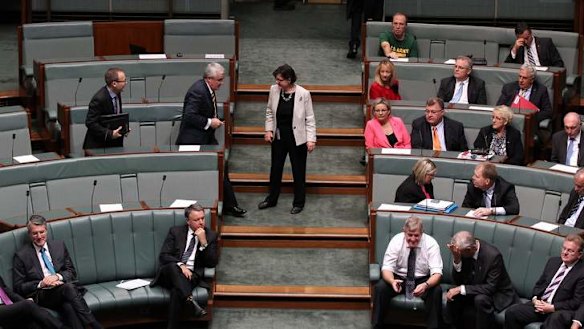 Greens MP Adam Bandt and Independent MPs Andrew Wilkie and Cathy McGowan move to vote with the Government during a division on the debt ceiling. Photo: Alex Ellinghausen