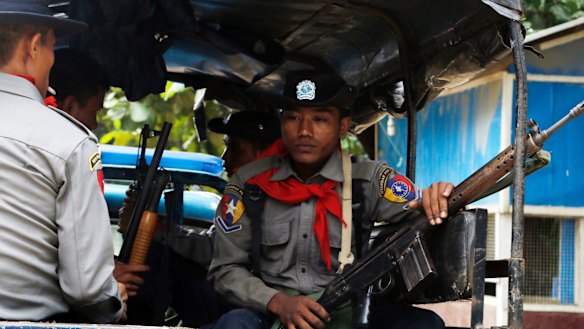Myanmar police officers sit in a truck as they provide security in Maungdaw, Rakhine State, Myanmar.